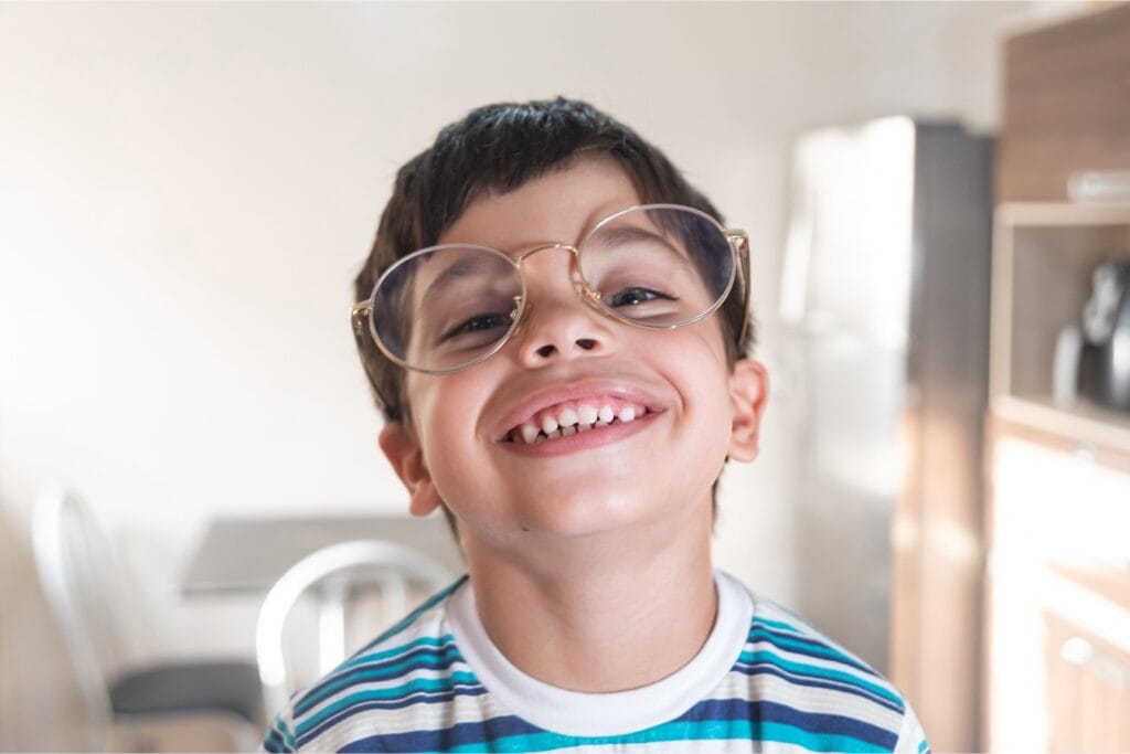 Young boy with glasses smiling