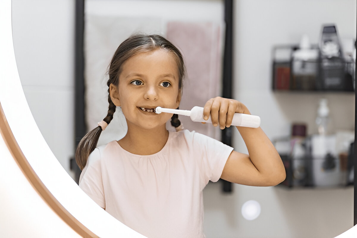 Teeth whitening Frisco TX at Dental Smart Kids: happy girl brushing