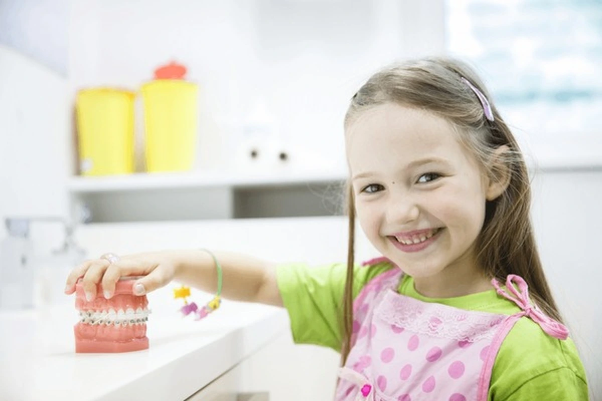 Dental crowns for kids Frisco TX at Dental Smart Kids: girl smiling with pink tooth mold