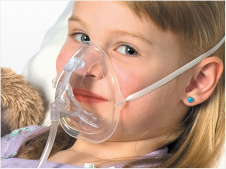General anesthesia Frisco TX child wearing oxygen mask for safe sedation at Dental Smart Kids
