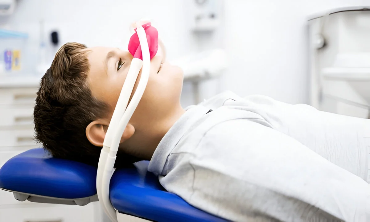 Laughing gas sedation Frisco TX child relaxing with nitrous oxide mask at Dental Smart Kids