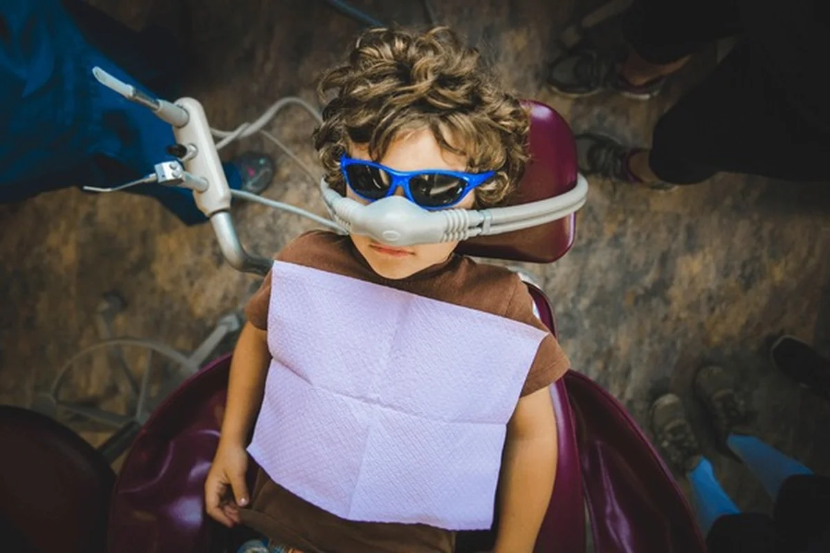 Laughing gas sedation Frisco TX child resting calmly with nitrous oxide mask at Dental Smart Kids