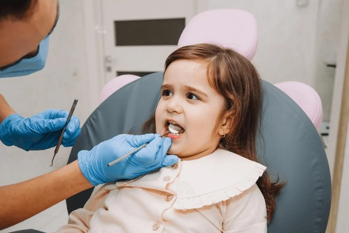 Pediatric nerve treatment Dental Smart Kids child receiving gentle dental examination in Frisco TX