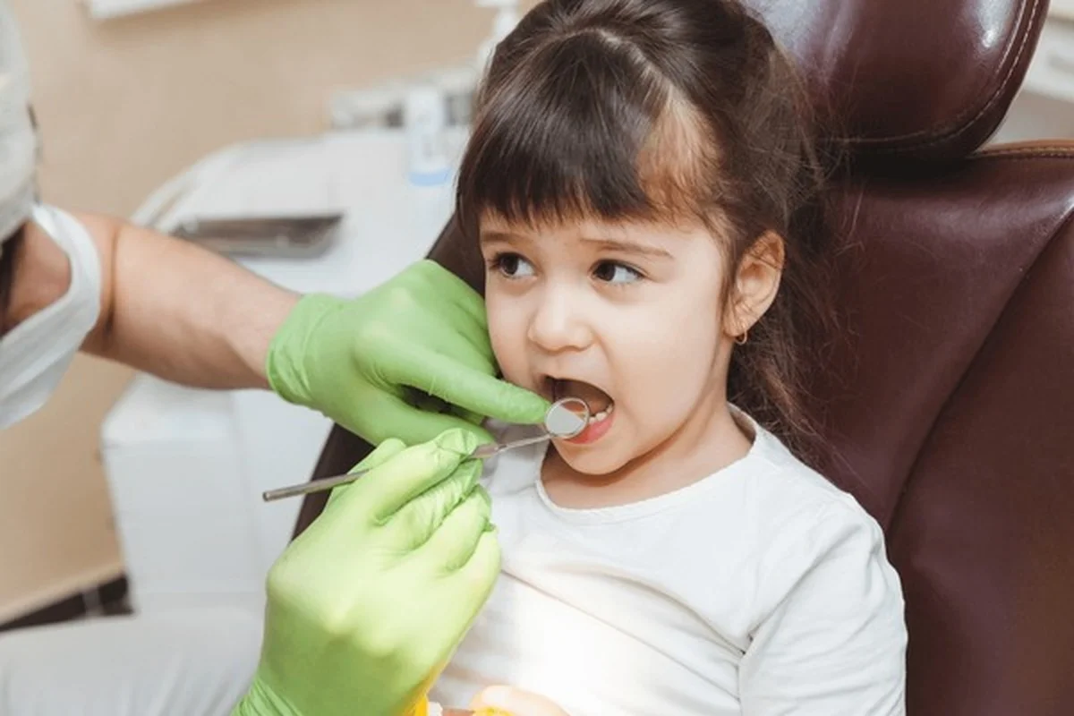 Pediatric nerve treatment Dental Smart Kids child receiving gentle dental examination in Frisco TX