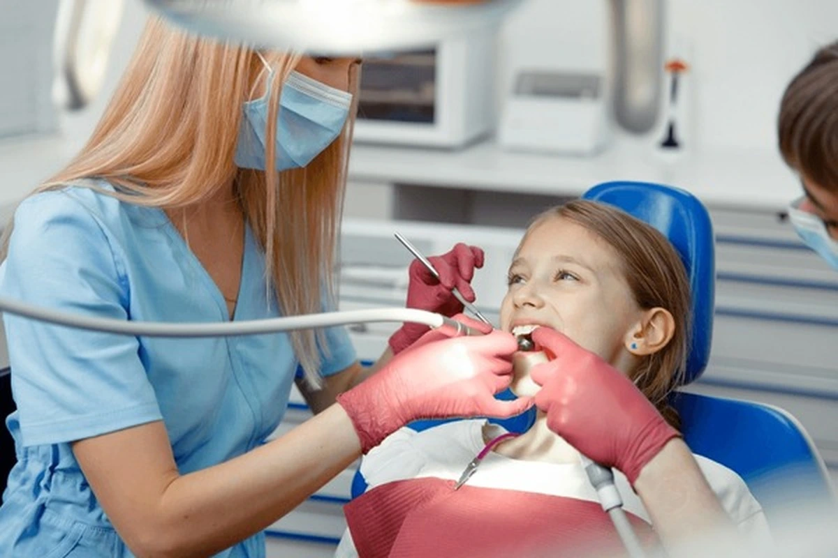 Special needs dentistry in Frisco TX as a pediatric dentist provides a gentle exam to a young patient at Smart Dental Kids.